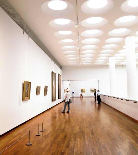 People looking at art on an upper floor corridor